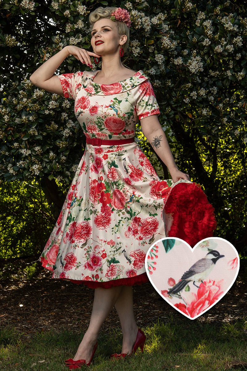 A lady wearing a Vintage Peony Floral Tea Dress In White & Pink