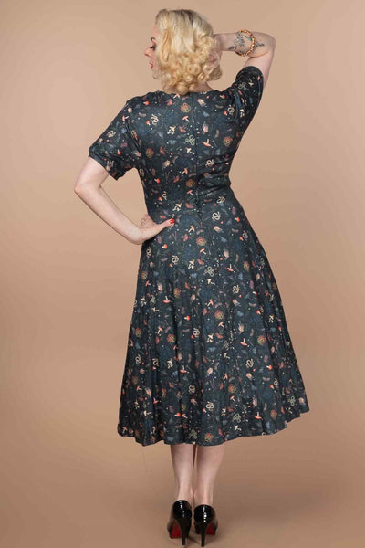 A model wearing a 50s Style Mystical Forest Dress