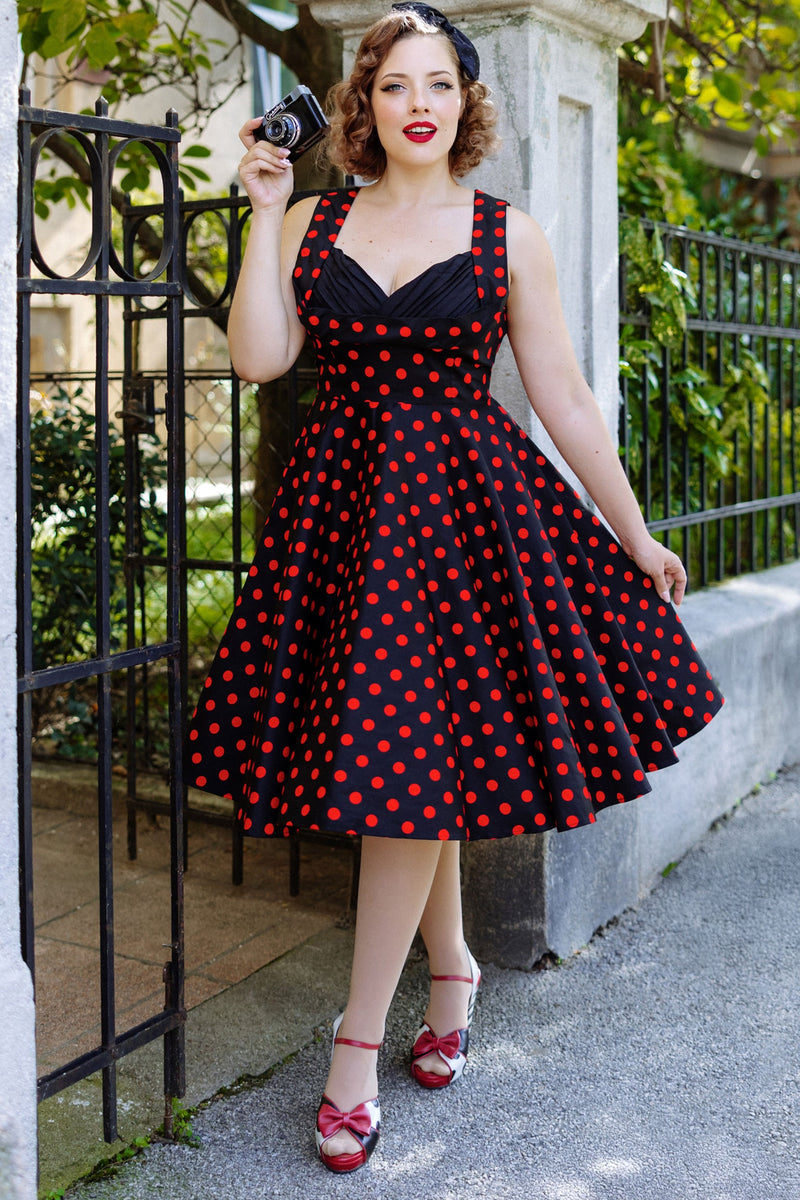 A model wearing Vintage Style Polka Dress in Black-Red