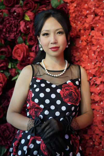 A model wearing a  Vintage Style Polka Roses Party Dress in Black-Red