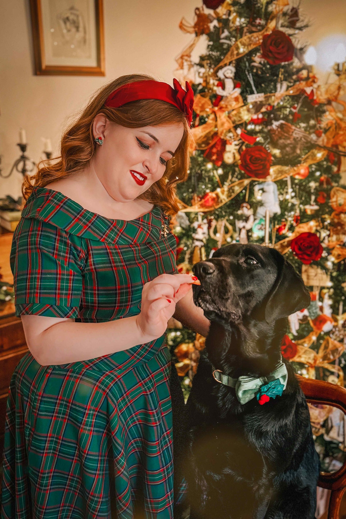 A model wearing a Vintage Swing Dress in Dark Green Plaid Print
