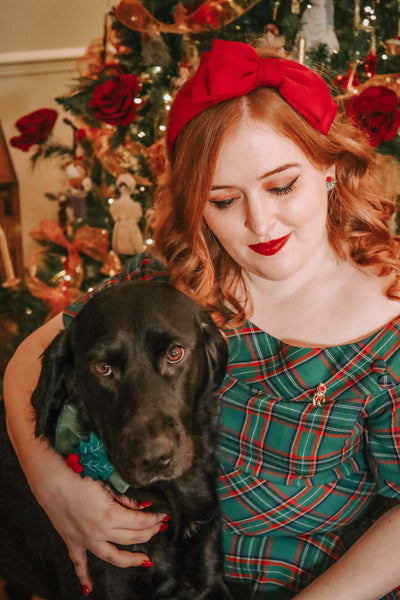 A model wearing a Vintage Swing Dress in Dark Green Plaid Print