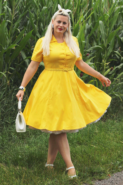 A lady wearing a Vintage Yellow Shirt Dress