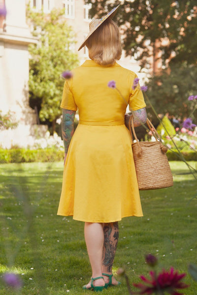 A lady wearing a Vintage Yellow Shirt Dress