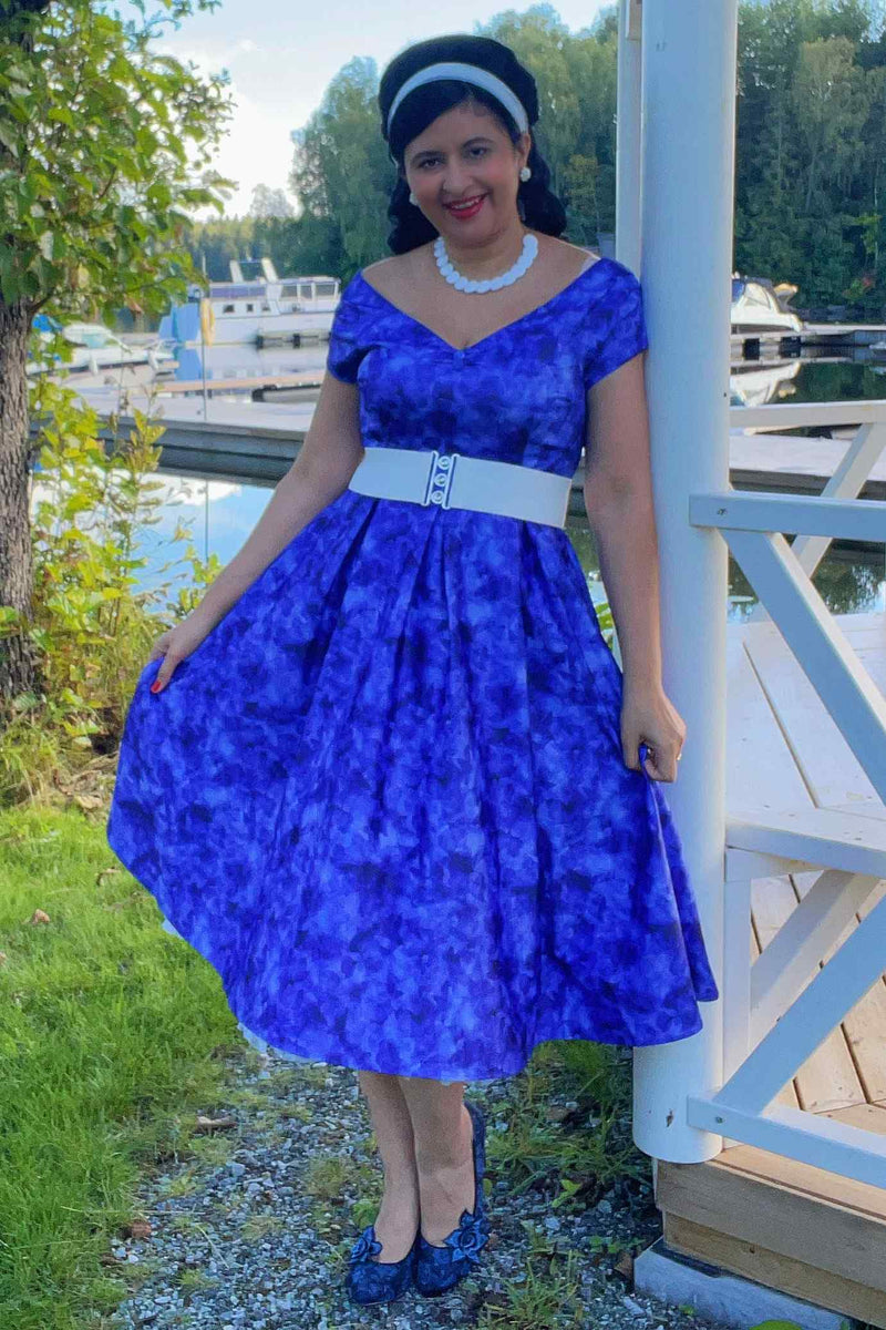 A model wearing a Lily Blue Watercolour Floral Off Shoulder Dress
