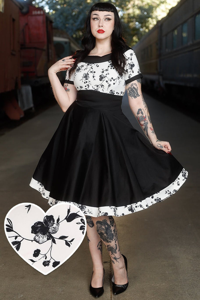 A model wearing White & Black Floral Roll Collar Dress