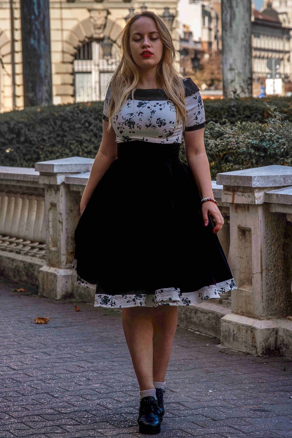 A model wearing a White & Black Floral Roll Collar Dress