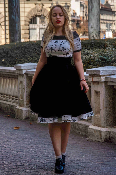 A model wearing a White & Black Floral Roll Collar Dress