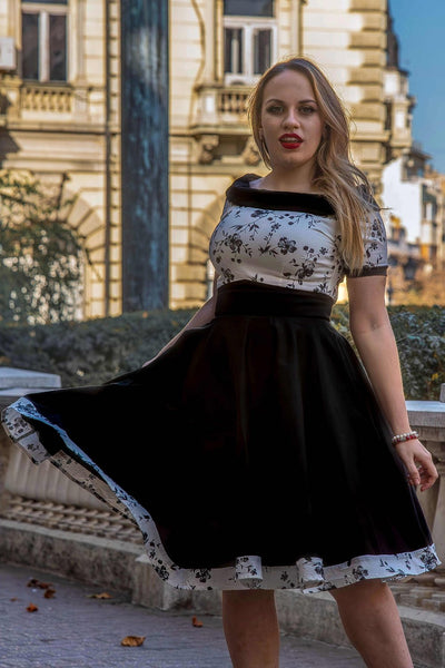 A model wearing a White & Black Floral Roll Collar Dress