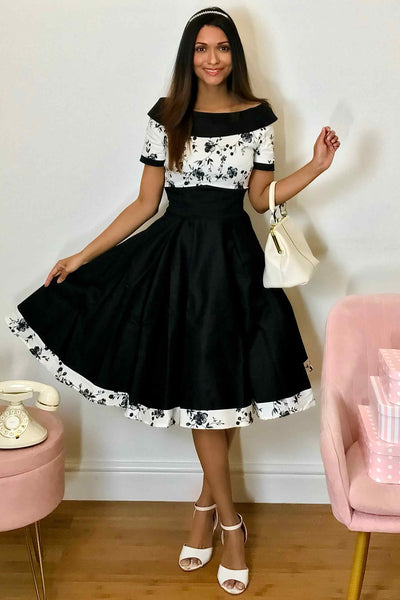 A model wearing White & Black Floral Roll Collar Dress