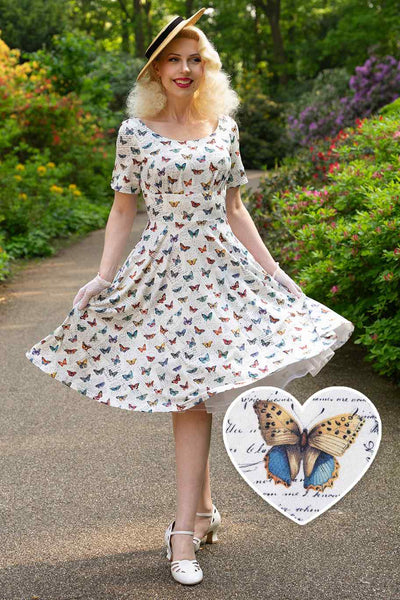 A model wearing White Butterfly Collection 50s Style Dress
