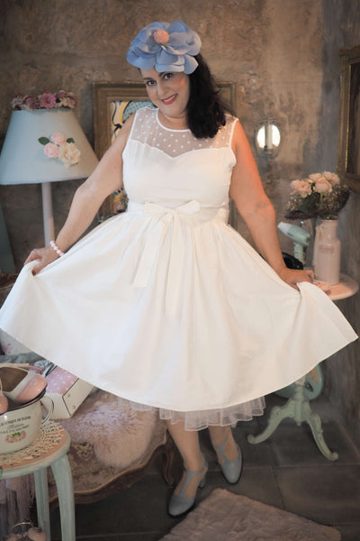 A lady wearing an Elizabeth White Mesh Panel Bridal Swing Dress