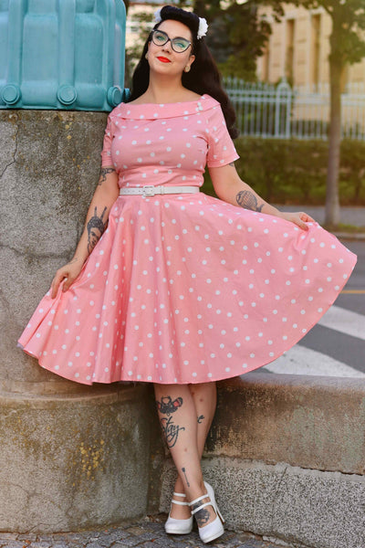 A model wearing a White Polka Dot Dress In Baby Pink