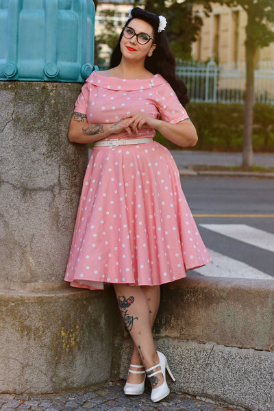 A model wearing a White Polka Dot Dress In Baby Pink