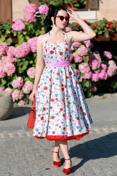 A woman wearing a Daisy White Rose Halter Dress