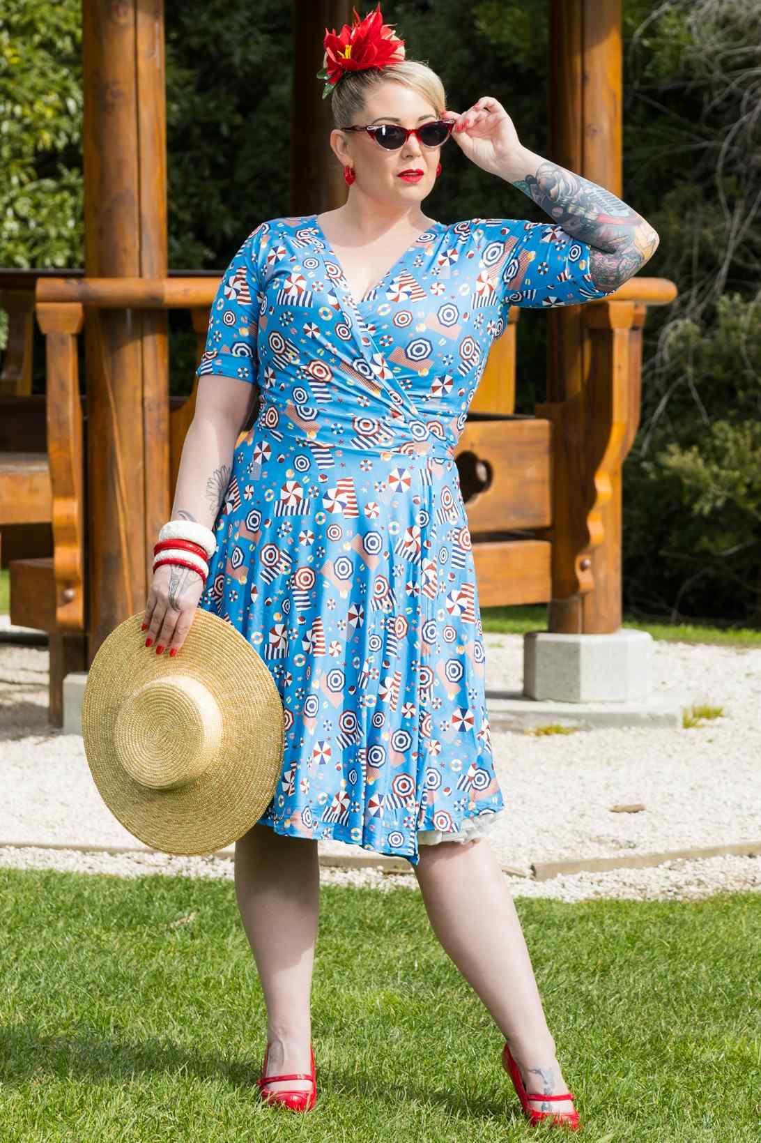 A model wearing a Matilda Wrap Dress In Blue Parasol Print