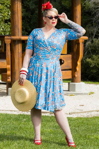 A model wearing a Matilda Wrap Dress In Blue Parasol Print