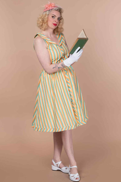A model wearing a Yellow Striped Shirt Dress