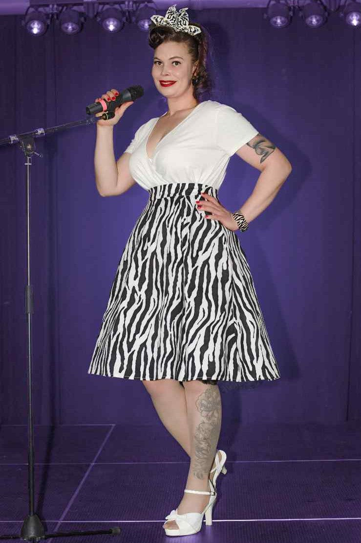 A lady wearing a Zebra Print Swing Skirt