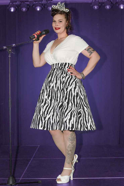 A lady wearing a Zebra Print Swing Skirt