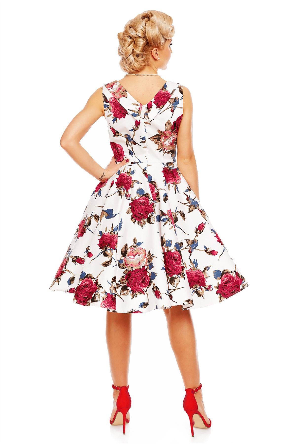 Model wearing Grace pleated bust dress, in white, with red roses, back view