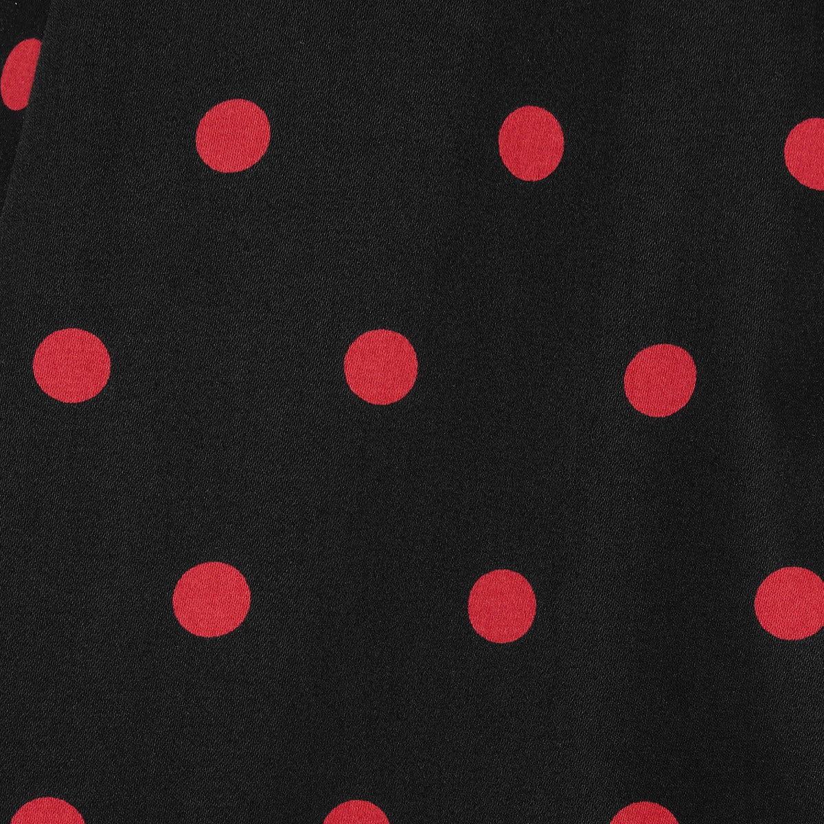 Black, with red polka dots, print close up