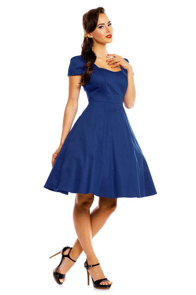 Model wearing a plain dark blue dress side view