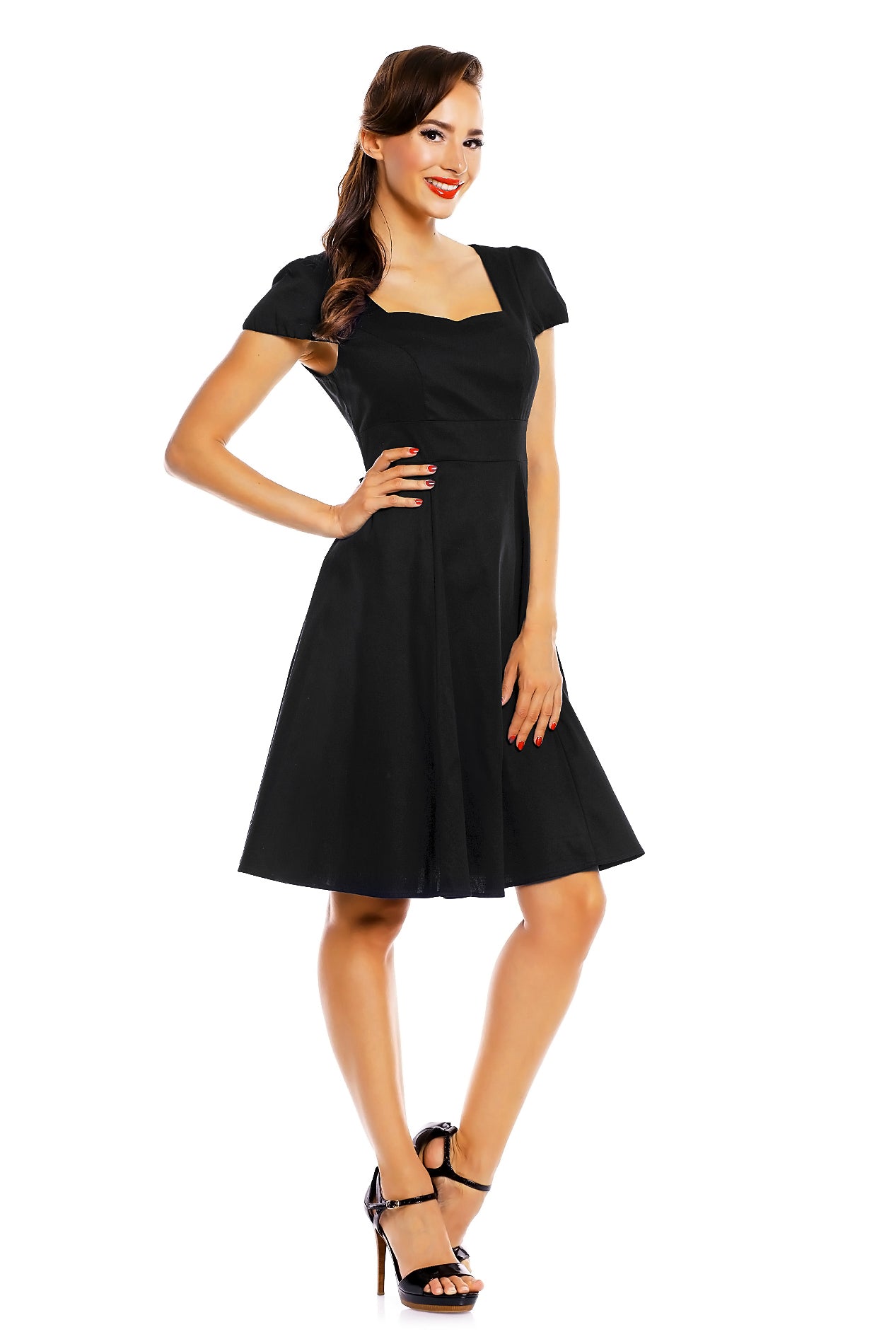Model wearing a plain black vintage dress