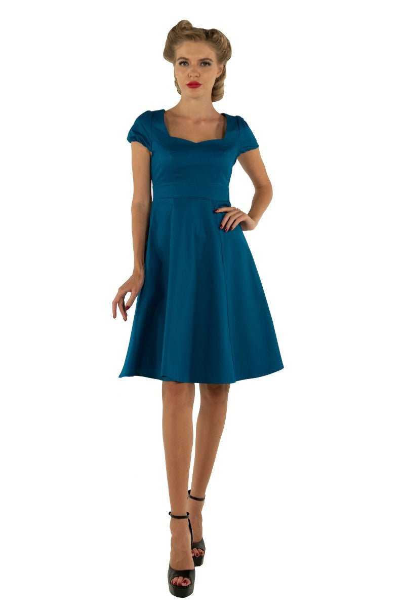 Model wearing plain teal blue 50's dress