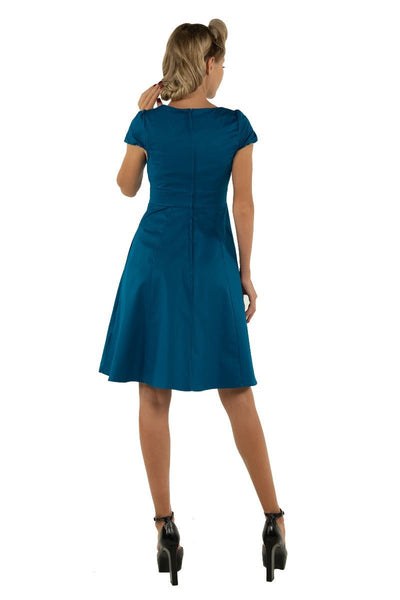 Model wearing plain teal blue 50's dress back view