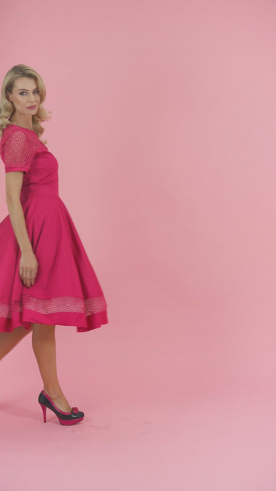 Video of a model posing, wearing our Tess Lace Sleeved Dress in Hot Pink.