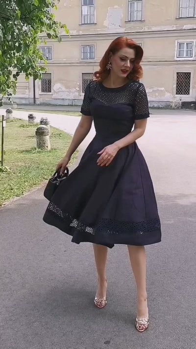 Video of a stunning brunette model wearing our  Tess Lace Sleeved Dress in Navy Blue.