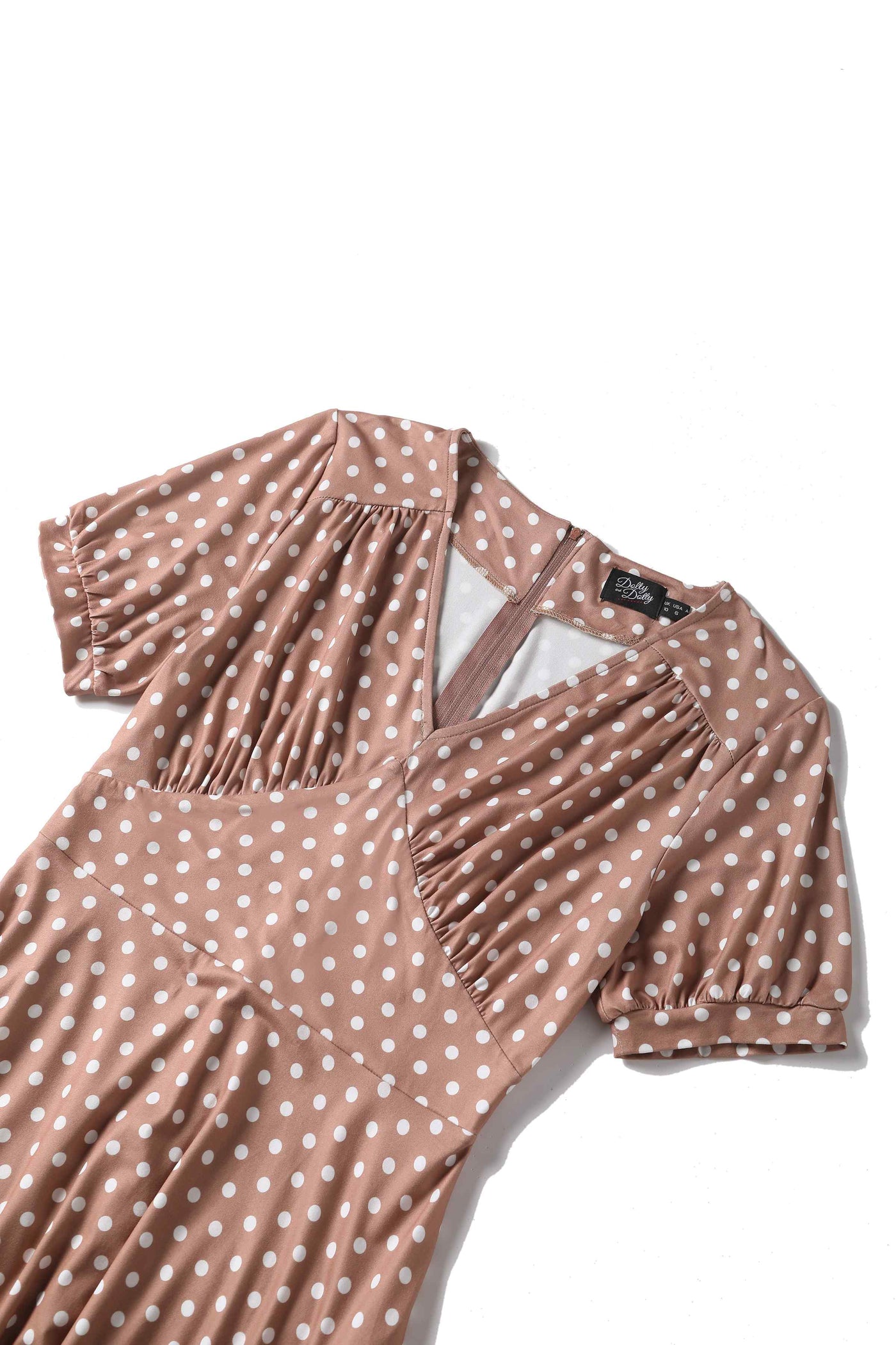 Close up view of 50s style brown and white polka dot swing dress