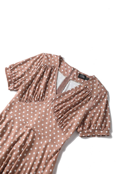 Close up view of 50s style brown and white polka dot swing dress