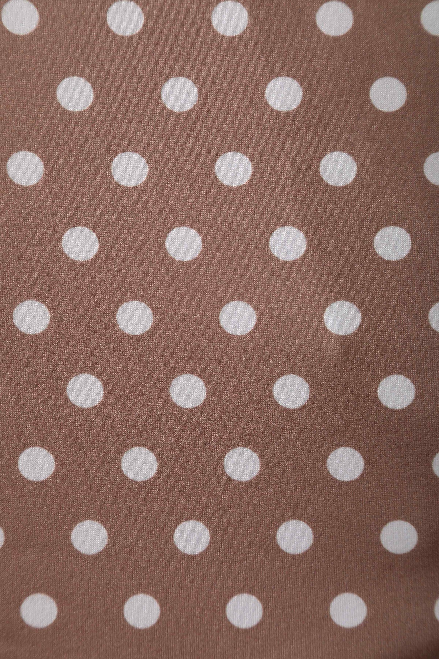 Fabric close up view of 50s style brown and white polka dot swing dress