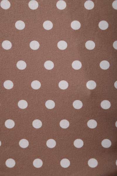 Fabric close up view of 50s style brown and white polka dot swing dress