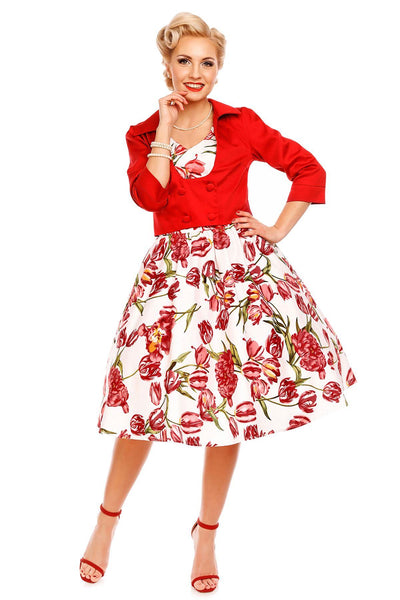 Model wearing our V neck May dress, in white, with pink tulips, with red jacket, front view