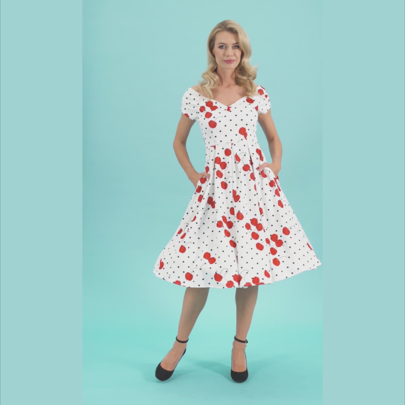Video of a woman wearing our Lily Rockabilly Polka & Cherry White Swing Dress.