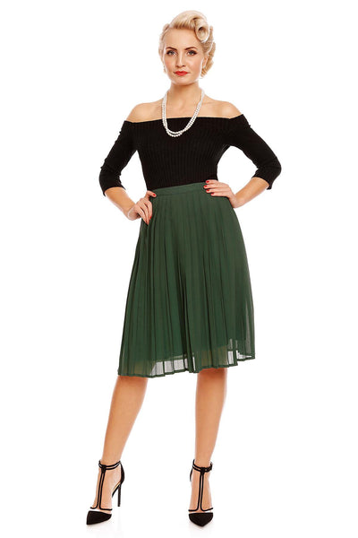 Model wearing our Gloria off-shoulder long sleeve top in black, with a green skirt, front view