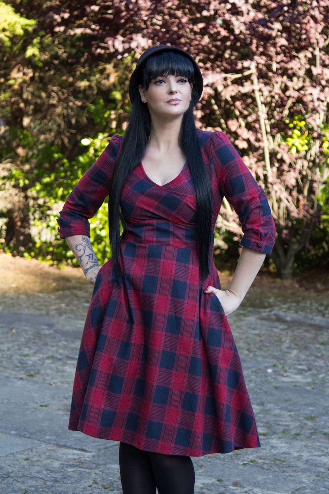 Influencer wearing red blue tartan sleeved flared dress