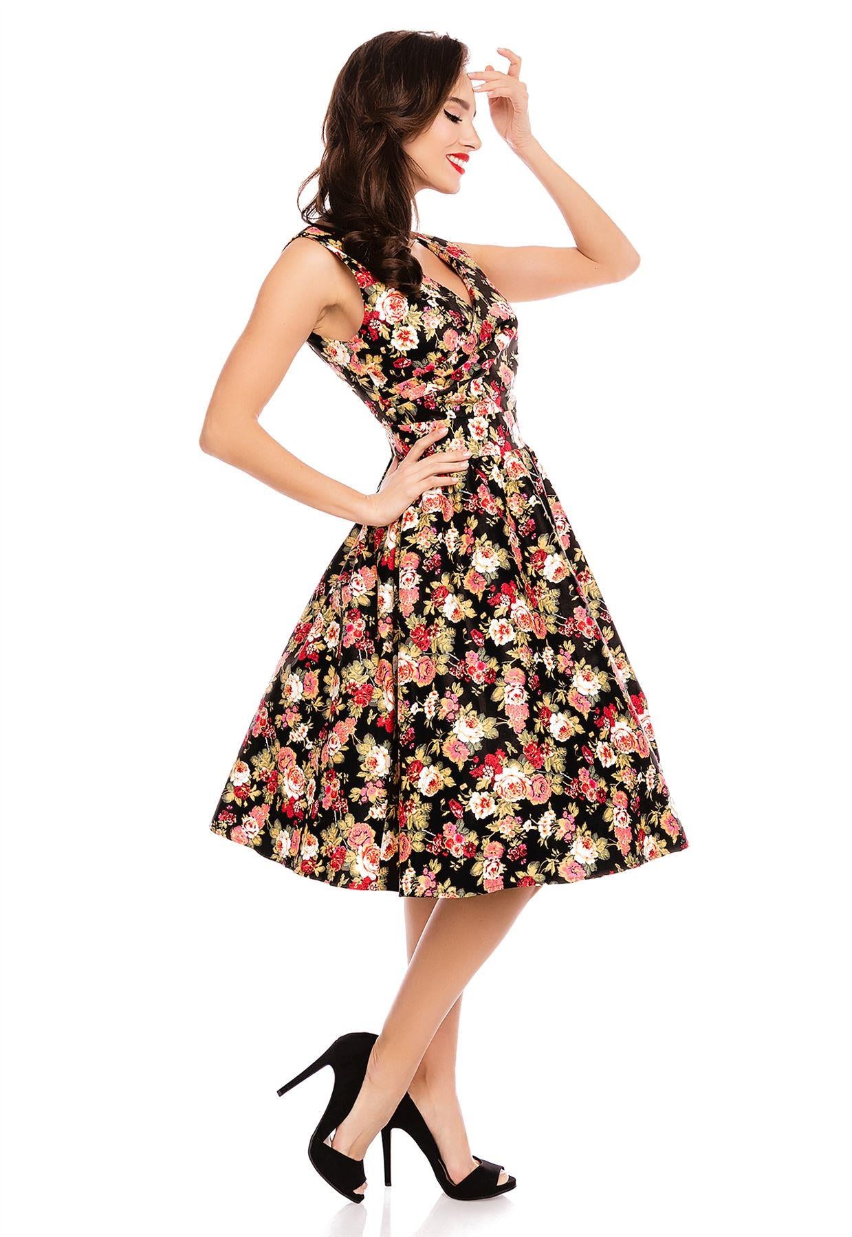 Model wearing our crossover bust May dress, in black/pink floral print, side view