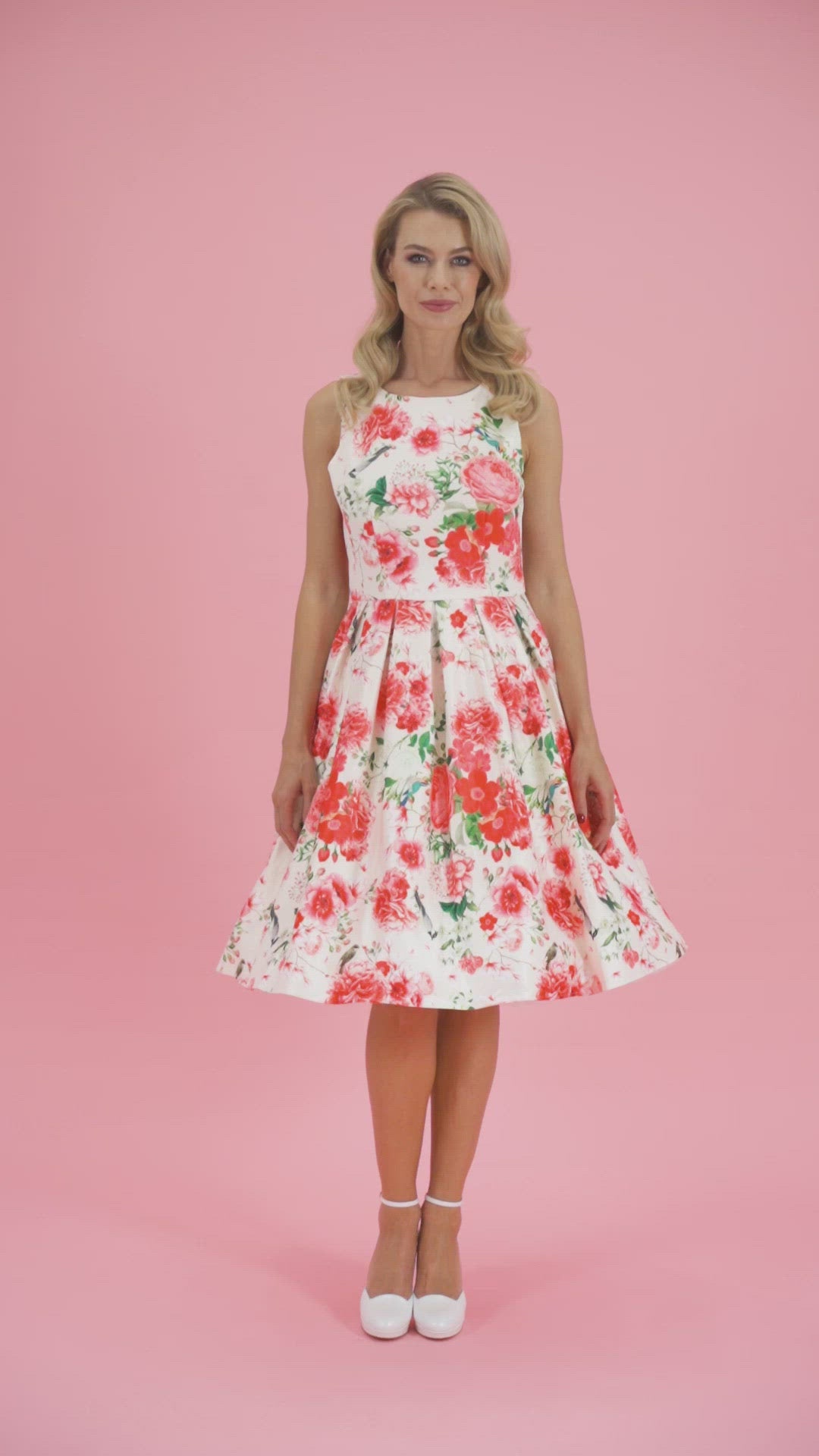 Video of a model twirling, wearing our Annie White Red Floral Swing Dress.