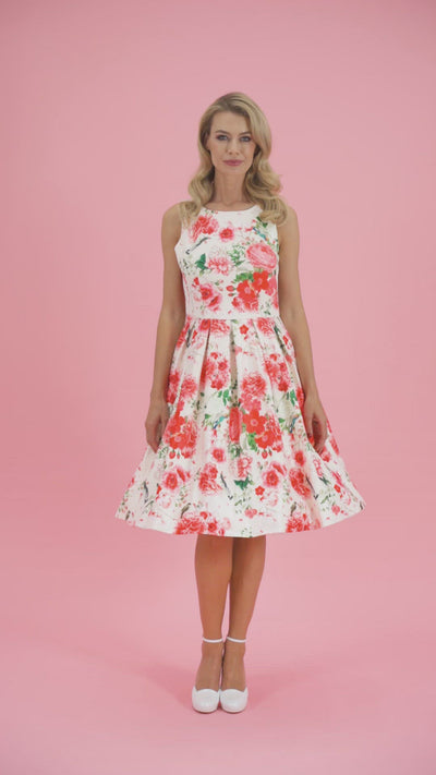 Video of a model twirling, wearing our Annie White Red Floral Swing Dress.