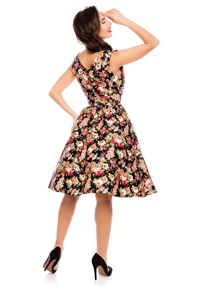 Model wearing our crossover bust May dress, in black/pink floral print, back view