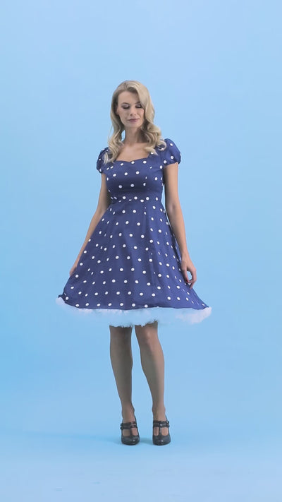 A video of a beautiful model wearing our Claudia Flirty Fifties Style Polka Dot Dress In Navy-White.