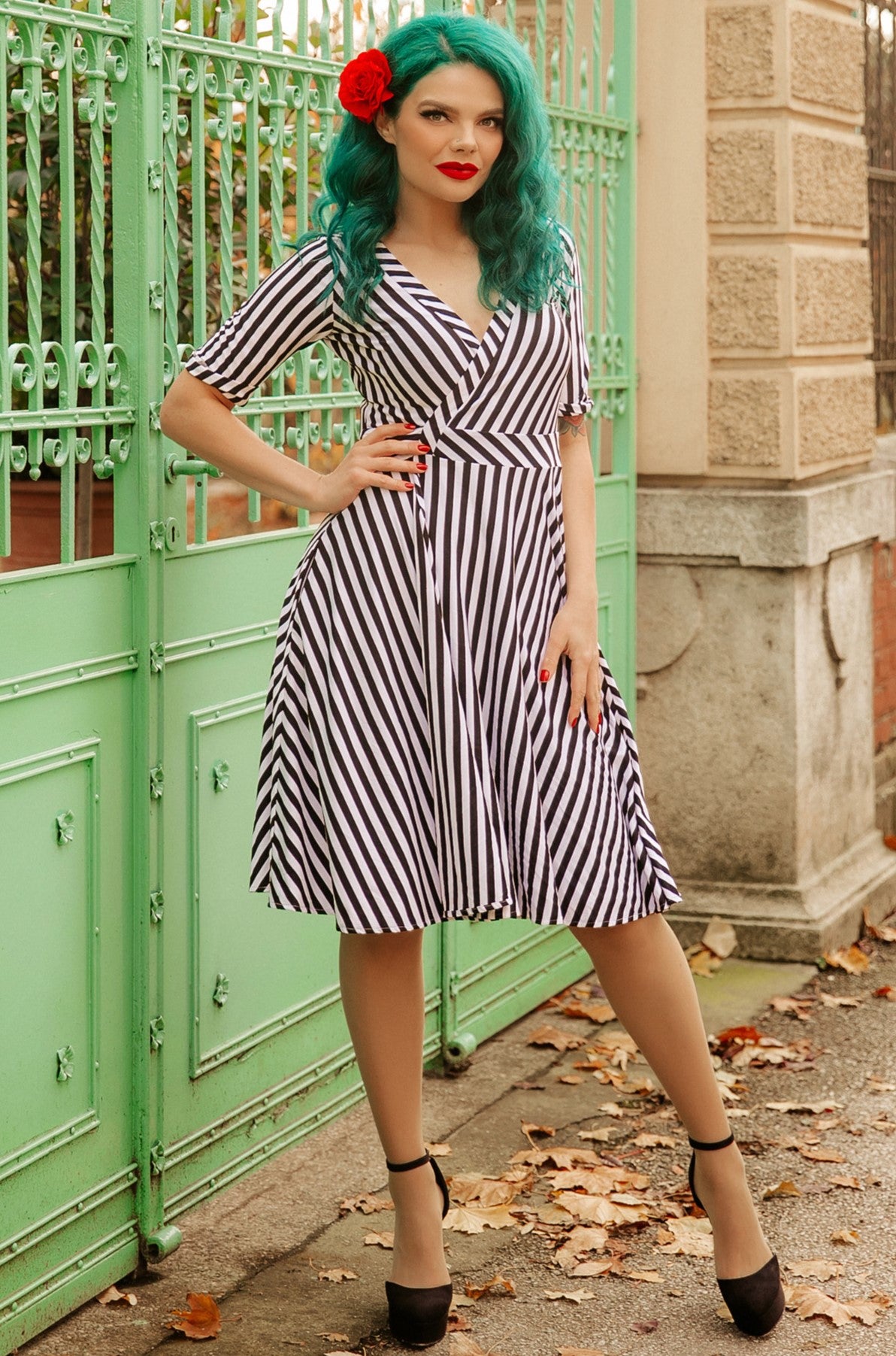 A model wearing Black & White Striped Knit Wrap Dress