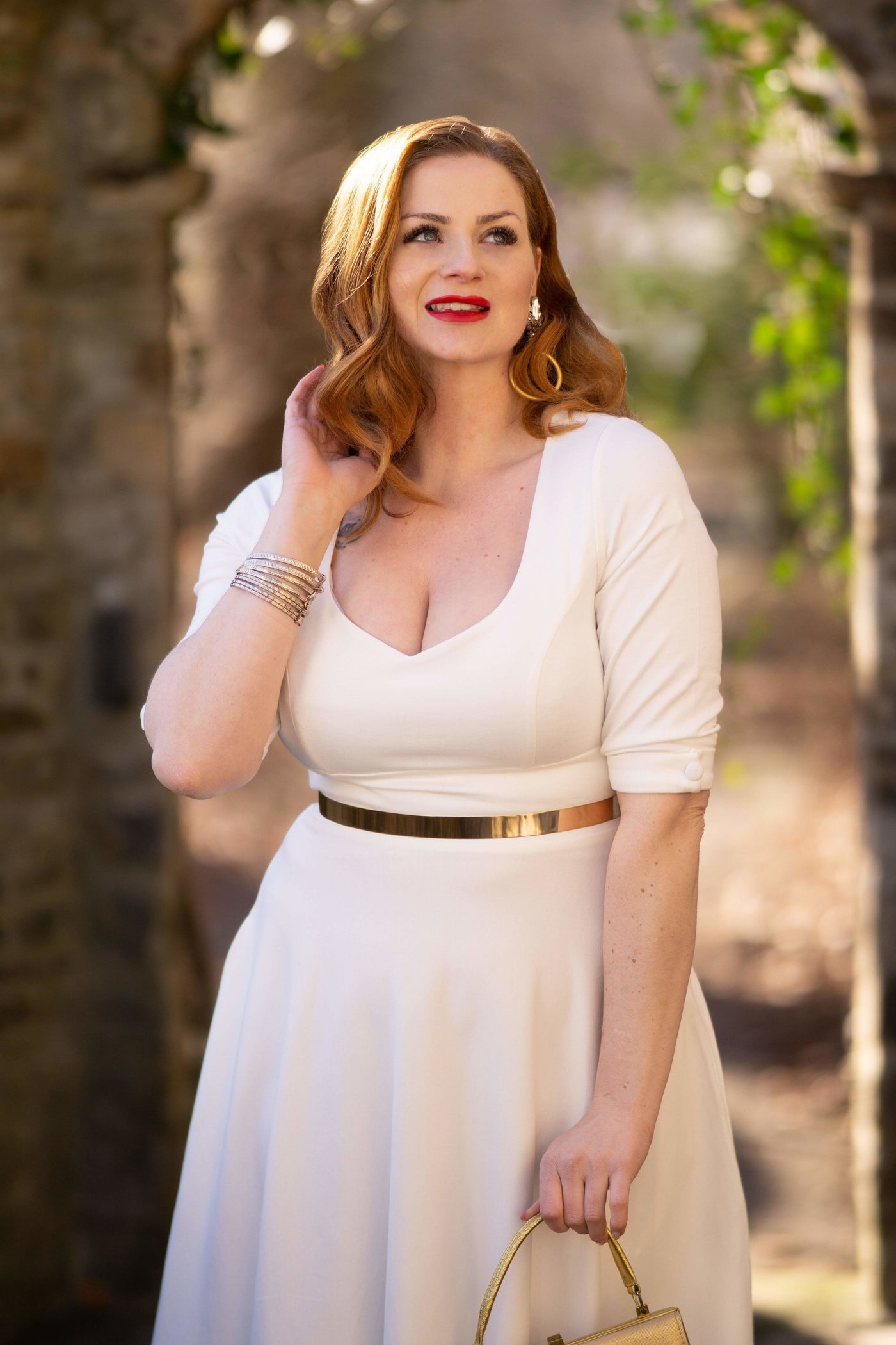 A model wearing Women's Bridal White Long Sleeved Midi Dress 