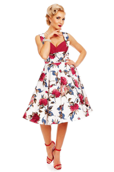 Model wearing Grace pleated bust dress, in white, with red roses, front view