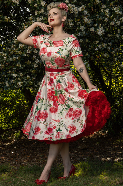 Influencer wearing white and pink floral vintage dress with red petticoat