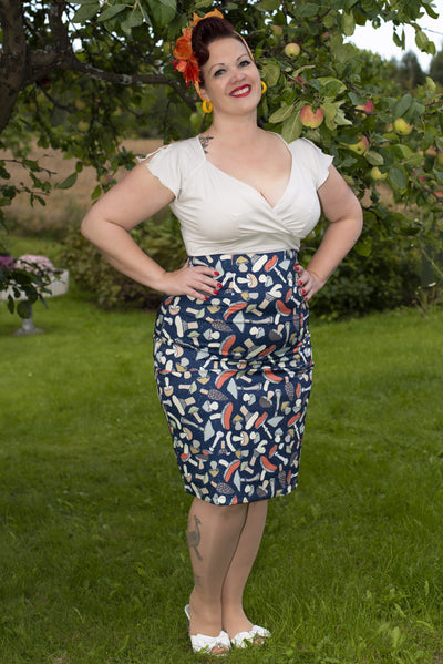 Influencer wearing navy blue mushroom print wiggle skirt and white top